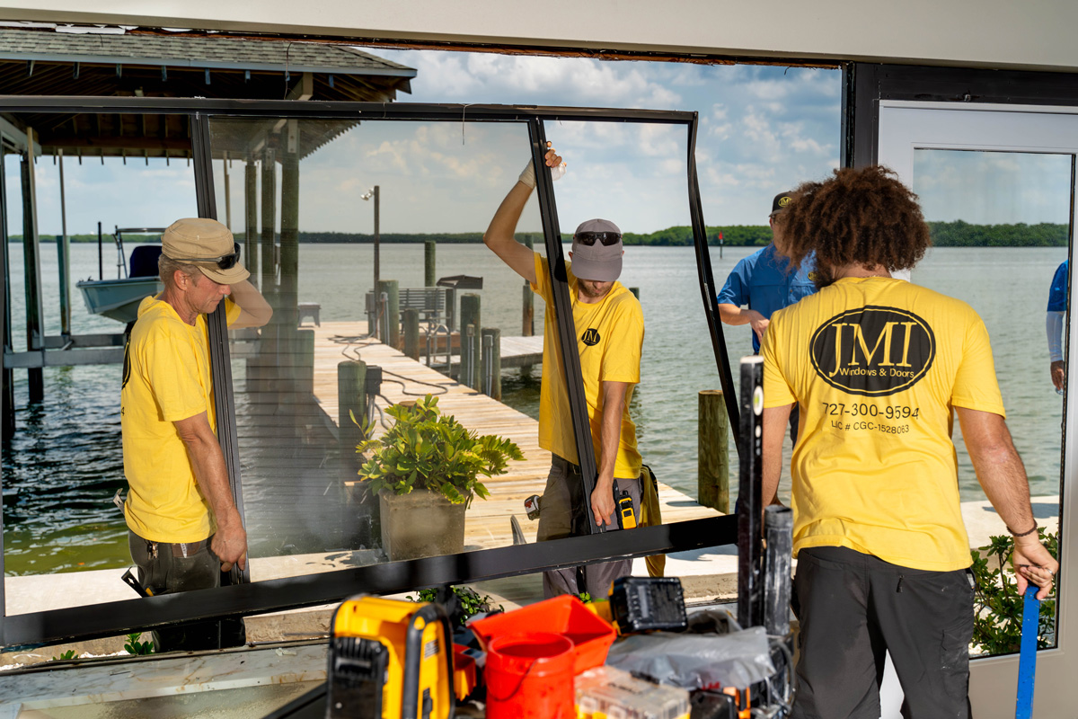Professional installation of impact-resistant windows in a Florida home for hurricane protection.